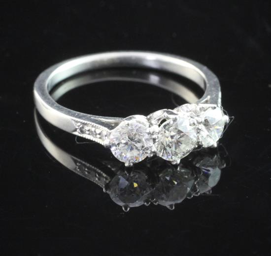 A platinum and three stone diamond ring, size L.